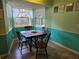 Sunny breakfast nook with a table, chairs, and view of the outdoor garden at 3446 Country Manor Dr, Port Orange, FL 32129