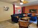 Comfortable living room with a blue sofa, ceiling fan, tile floor, and colorful accents at 3446 Country Manor Dr, Port Orange, FL 32129