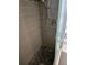 Sleek walk-in shower with gray tiling, a pebble floor, and modern fixtures at 3446 Country Manor Dr, Port Orange, FL 32129