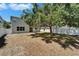 Spacious backyard featuring a large tree with ample shade and an enclosed fence at 2415 Brownwood Dr, Mulberry, FL 33860