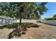 Backyard with privacy fence and large tree providing ample shade at 2415 Brownwood Dr, Mulberry, FL 33860