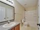 Bathroom featuring a single vanity, framed mirror, updated fixtures, and shower-tub combo at 2415 Brownwood Dr, Mulberry, FL 33860