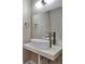 Bathroom features a modern sink with a chrome faucet, a large mirror, and stylish wall-mounted accessories at 2415 Brownwood Dr, Mulberry, FL 33860