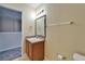 Bathroom featuring a granite vanity, framed mirror, updated fixtures, and warm, inviting paint color at 2415 Brownwood Dr, Mulberry, FL 33860