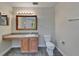 Bright en suite bathroom vanity with a stone counter and a modern toilet at 2415 Brownwood Dr, Mulberry, FL 33860