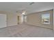 Spacious bedroom showing carpeting, natural light, and access to en suite bathroom at 2415 Brownwood Dr, Mulberry, FL 33860