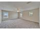 Spacious bedroom featuring neutral tones, plush carpeting, and a ceiling fan at 2415 Brownwood Dr, Mulberry, FL 33860
