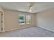 Bedroom with soft carpeting, bright windows, ceiling fan, and neutral color scheme at 2415 Brownwood Dr, Mulberry, FL 33860