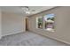 Bedroom with soft carpeting, bright windows, ceiling fan, and neutral color scheme at 2415 Brownwood Dr, Mulberry, FL 33860