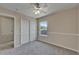 Cozy bedroom with a ceiling fan, closet, and window overlooking the backyard at 2415 Brownwood Dr, Mulberry, FL 33860