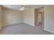 Bedroom with soft carpeting, ceiling fan, neutral color scheme and adjoining open door at 2415 Brownwood Dr, Mulberry, FL 33860