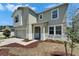Two-story home boasts an attached two-car garage, front lawn, and well-manicured garden at 2415 Brownwood Dr, Mulberry, FL 33860