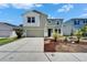 Two-story home boasts a well-manicured front yard with mature landscaping and an attached two-car garage at 2415 Brownwood Dr, Mulberry, FL 33860