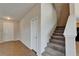 Bright foyer features tile flooring, white painted brick, and carpeted stairs to the second floor at 2415 Brownwood Dr, Mulberry, FL 33860