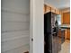 View of a kitchen with wooden cabinets and black appliances next to a walk-in pantry at 2415 Brownwood Dr, Mulberry, FL 33860