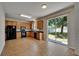 Spacious kitchen with tile floors, wood cabinets, and a sliding glass door to the backyard at 2415 Brownwood Dr, Mulberry, FL 33860