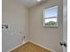 Bright laundry room with tile flooring, window, and washer/dryer hookups at 2415 Brownwood Dr, Mulberry, FL 33860