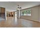 Open-concept living area with tile flooring, seamlessly connecting the living room, kitchen, and staircase at 2415 Brownwood Dr, Mulberry, FL 33860