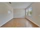 Living room with tile floors, neutral wall color, and two windows at 2415 Brownwood Dr, Mulberry, FL 33860
