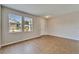 Living room with tile floors, neutral wall color, two windows and a doorway at 2415 Brownwood Dr, Mulberry, FL 33860