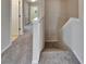Carpeted stairway with white trim and a view of the hallway upstairs at 2415 Brownwood Dr, Mulberry, FL 33860