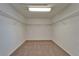 Spacious walk-in closet with wire shelving, neutral carpeting, and ample room for storage at 2415 Brownwood Dr, Mulberry, FL 33860