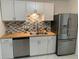 Updated kitchen boasts stainless steel appliances, tile backsplash, and sleek countertops at 3601 Ne 24Th Ct, Ocala, FL 34479