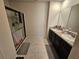Bathroom featuring double sinks, granite countertops, and a walk-in shower at 1204 Berry Ln, Davenport, FL 33837