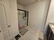 Bathroom featuring a walk-in shower, neutral tile flooring, and a modern vanity at 1204 Berry Ln, Davenport, FL 33837