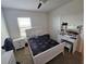 Sunlit bedroom with ceiling fan, neutral color scheme and furniture, and bright light from the window at 1204 Berry Ln, Davenport, FL 33837