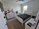 Cozy bedroom with white furniture, patterned bedspread, ceiling fan, and a window for natural light at 1204 Berry Ln, Davenport, FL 33837