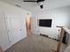 Unfurnished room with carpet flooring, a ceiling fan, and a wall-mounted TV, ready to be personalized at 1204 Berry Ln, Davenport, FL 33837