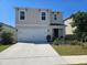 Charming two-story home featuring a two-car garage and well-manicured front yard at 1204 Berry Ln, Davenport, FL 33837