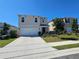 Charming two-story home featuring a two-car garage and well-manicured front yard at 1204 Berry Ln, Davenport, FL 33837