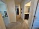 Hallway with carpet floor and access to the bathroom and another room at 1204 Berry Ln, Davenport, FL 33837