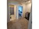 Interior showcasing doorway views of a bathroom and bedroom, connected by carpeted flooring at 1204 Berry Ln, Davenport, FL 33837