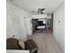 View of a modern living room with a ceiling fan, built-in shelving unit, and neutral carpeting at 1204 Berry Ln, Davenport, FL 33837