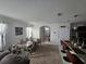 Open floor plan with living room, dining area, and kitchen island with barstool seating at 1204 Berry Ln, Davenport, FL 33837