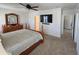 Spacious bedroom featuring a four-poster bed, ceiling fan, and a matching dresser with large mirror at 1204 Berry Ln, Davenport, FL 33837