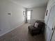 Cozy sitting area featuring neutral carpeting and a comfortable recliner chair at 1204 Berry Ln, Davenport, FL 33837