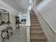 Carpeted stairway with white banister leading to the second floor of the house at 1204 Berry Ln, Davenport, FL 33837