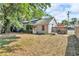 Charming backyard featuring mature trees providing natural shade and a well-maintained lawn at 1480 E Davidson St, Bartow, FL 33830