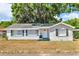 Charming one-story home featuring a neutral exterior, well-maintained lawn and traditional architectural details at 1480 E Davidson St, Bartow, FL 33830