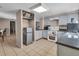 An interior view of the kitchen featuring neutral tiling, light blue cabinetry, and appliances at 1480 E Davidson St, Bartow, FL 33830
