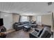 View of the living room with a large sectional, neutral walls, and ample space for relaxing and entertaining at 1480 E Davidson St, Bartow, FL 33830