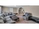 Cozy living room featuring a large sectional sofa, neutral walls, and an open archway at 1480 E Davidson St, Bartow, FL 33830
