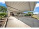 Carport of home showing golf cart, manicured bushes, covered entry, and access to Florida room at 1610 Reynolds Rd # 353, Lakeland, FL 33801