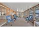 Relaxing sunroom featuring wood paneled walls and large windows overlooking outside at 1610 Reynolds Rd # 353, Lakeland, FL 33801
