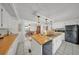 Open-concept kitchen with white cabinets, wood counters, tile flooring, and stainless steel appliances at 1610 Reynolds Rd # 353, Lakeland, FL 33801