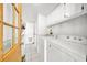 Efficient laundry room with tile flooring, cabinets for storage, and washer and dryer at 1610 Reynolds Rd # 353, Lakeland, FL 33801